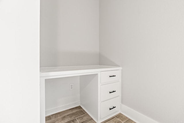 interior space featuring baseboards and wood tiled floor