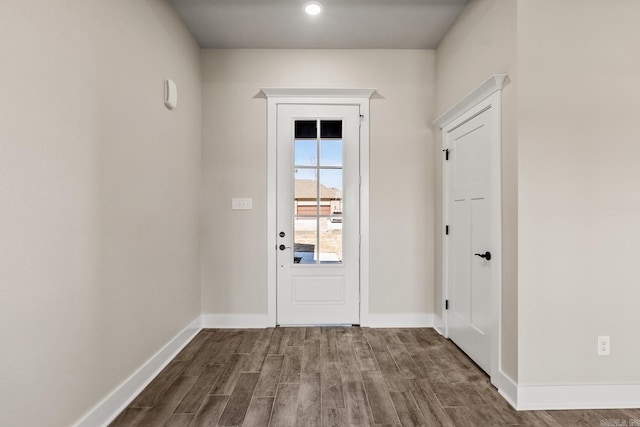 doorway to outside featuring dark wood-style floors and baseboards