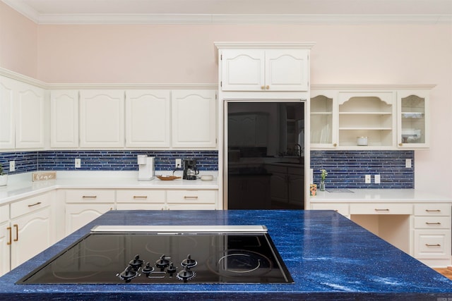 kitchen featuring white cabinetry, black appliances, tasteful backsplash, and ornamental molding