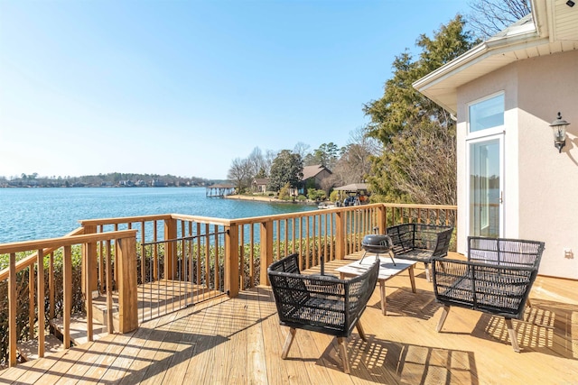 deck with a water view and an outdoor hangout area