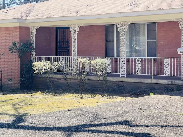 view of front facade featuring a porch and brick siding