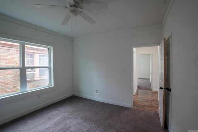 unfurnished room featuring baseboards, carpet, ceiling fan, and crown molding