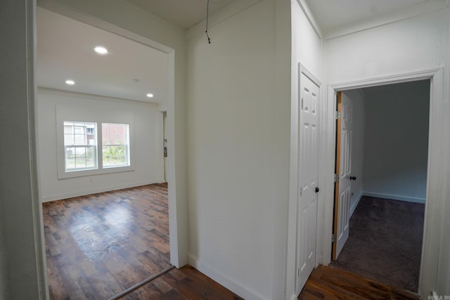 corridor featuring recessed lighting, baseboards, and dark wood-style flooring