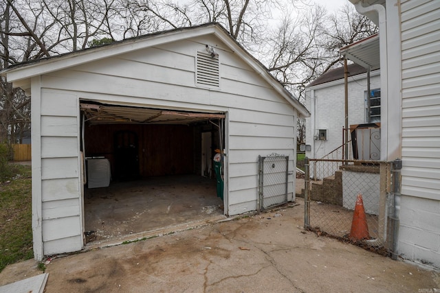 detached garage with driveway and fence