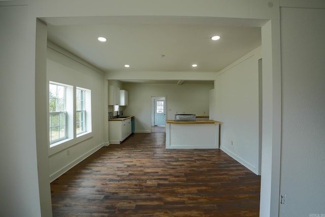 kitchen with recessed lighting, baseboards, dark wood-type flooring, and white cabinetry