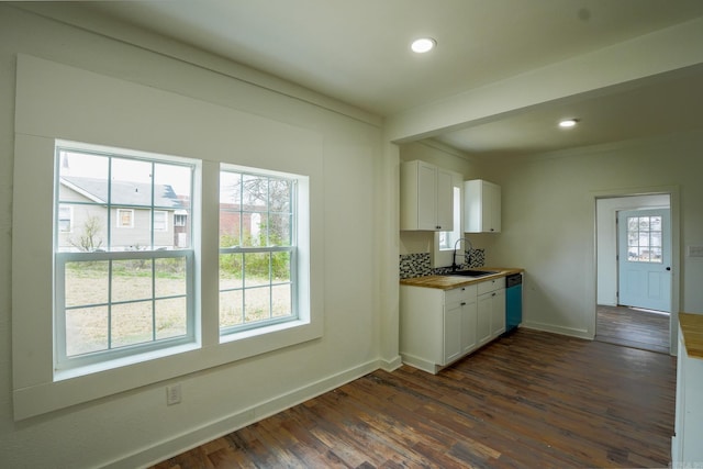 kitchen with dishwashing machine, dark wood-style floors, a sink, white cabinetry, and a wealth of natural light