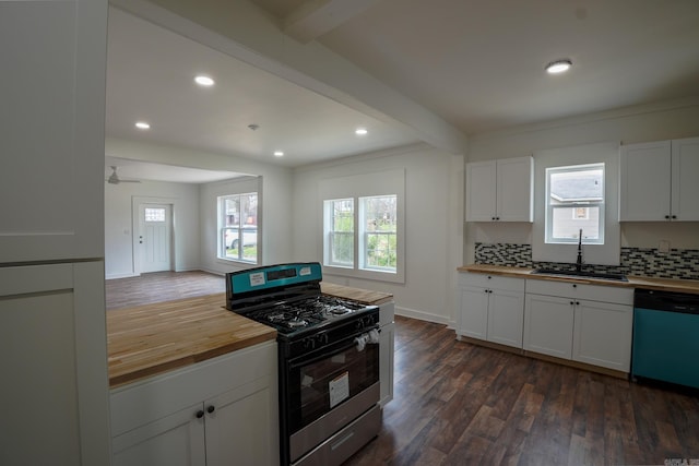 kitchen featuring dishwasher, gas stove, wood counters, and a sink