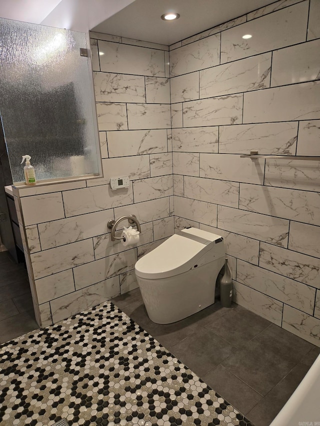 full bath featuring tile walls, toilet, tile patterned floors, and tiled shower