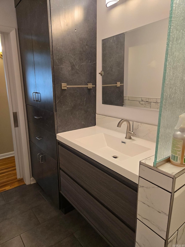 bathroom featuring vanity, tile patterned floors, and tile walls