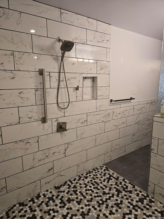 full bathroom featuring tile walls and a tile shower