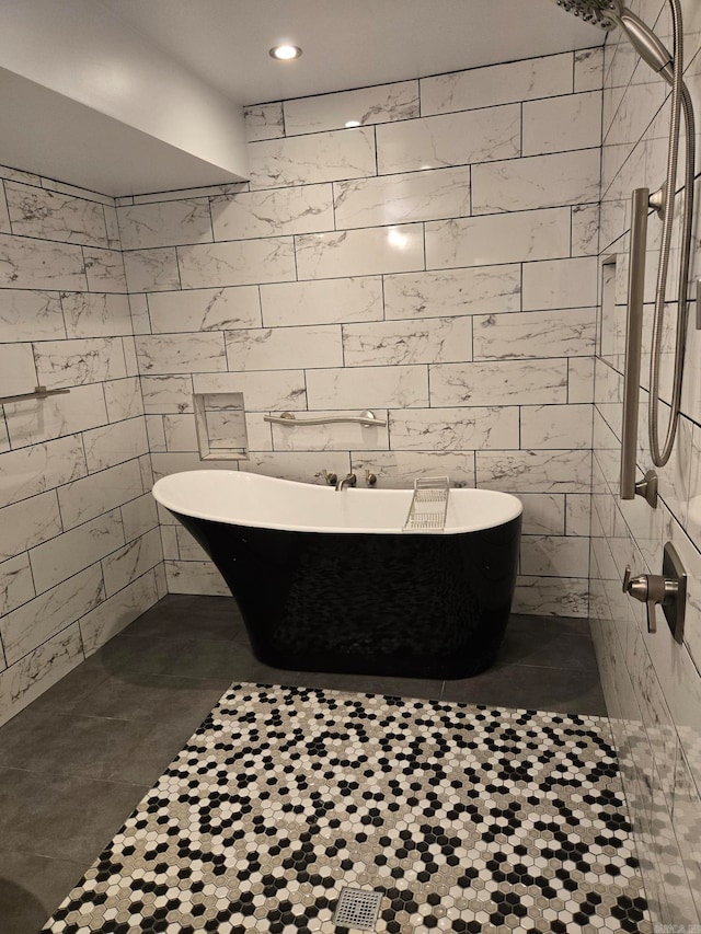 bathroom featuring a tile shower and a freestanding bath