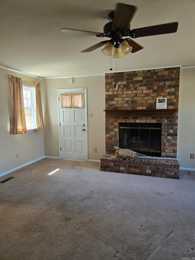 unfurnished living room with a ceiling fan, visible vents, carpet floors, a fireplace, and ornamental molding