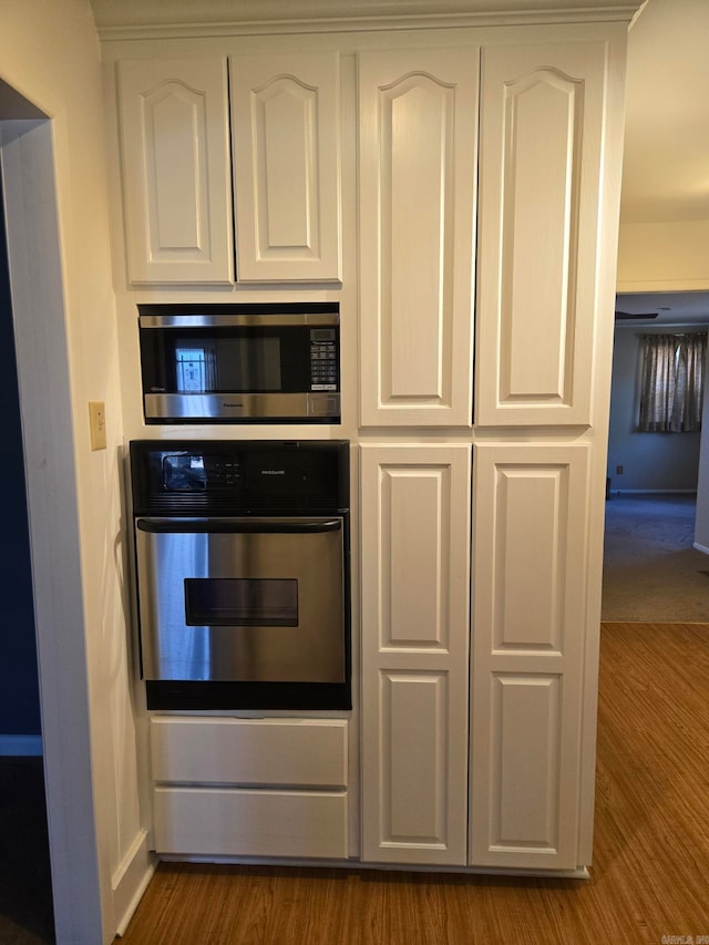 kitchen featuring white cabinetry, dark wood-style flooring, and stainless steel appliances