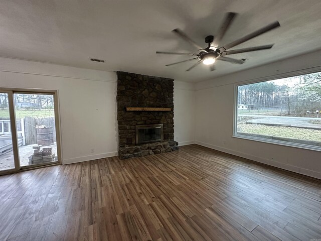 unfurnished living room featuring visible vents, wood finished floors, and a ceiling fan