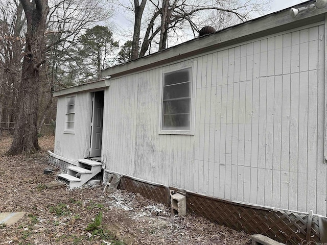 view of side of property featuring entry steps