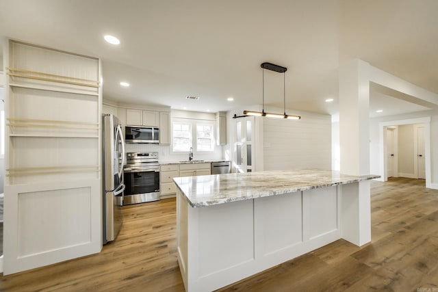 kitchen featuring a sink, visible vents, appliances with stainless steel finishes, and light wood-style flooring