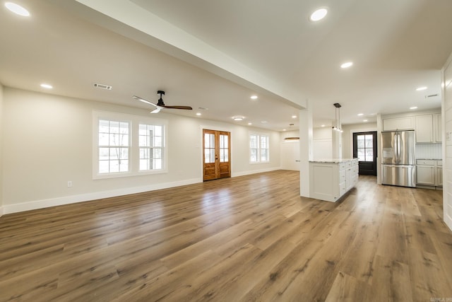 unfurnished living room featuring light wood-type flooring, visible vents, and recessed lighting