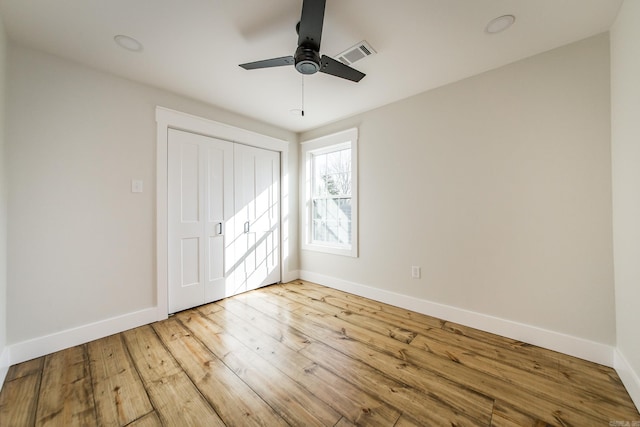 unfurnished bedroom with visible vents, baseboards, ceiling fan, light wood-style flooring, and a closet