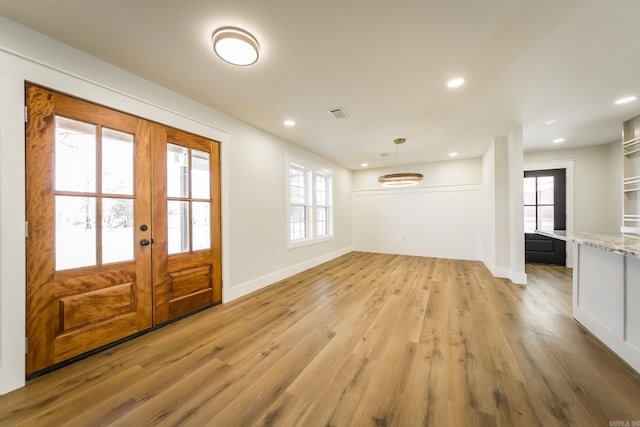 entrance foyer featuring recessed lighting, light wood-type flooring, baseboards, and french doors