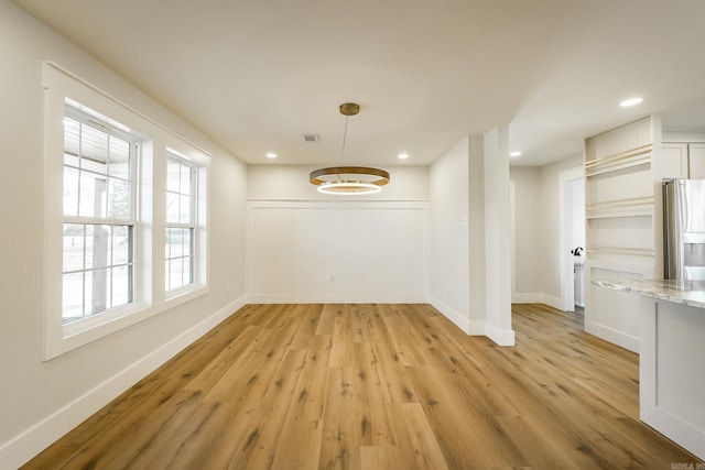 unfurnished dining area with recessed lighting, light wood-style flooring, visible vents, and baseboards