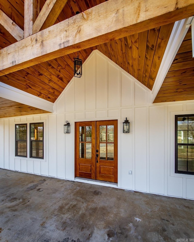 doorway to property with a patio area, french doors, and board and batten siding