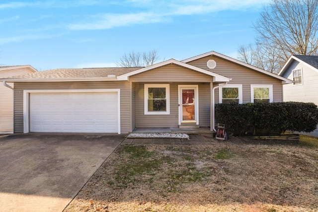 ranch-style home with an attached garage and concrete driveway