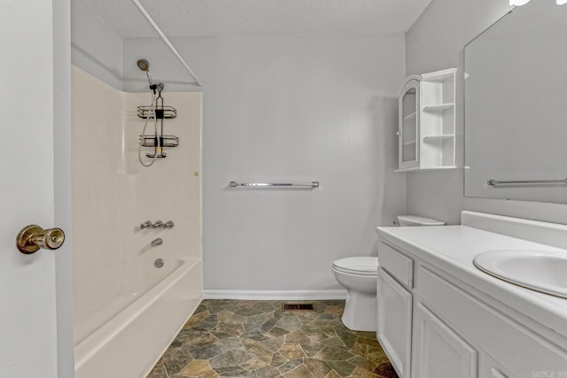 bathroom featuring toilet, stone finish floor, a textured ceiling, baseboards, and vanity