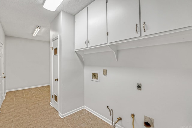 washroom featuring baseboards, gas dryer hookup, hookup for a washing machine, cabinet space, and hookup for an electric dryer