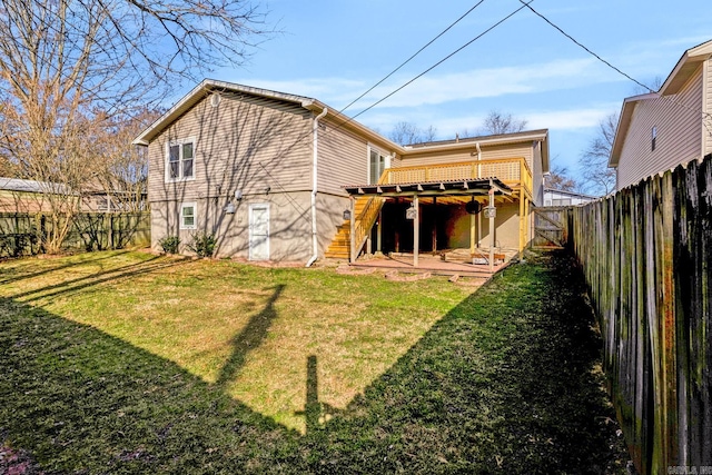 rear view of property with a yard, a wooden deck, stairs, and a fenced backyard