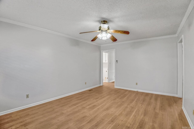 unfurnished room with a textured ceiling, ornamental molding, baseboards, and ceiling fan