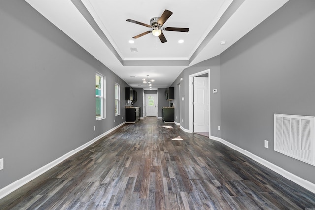 unfurnished living room featuring dark wood-style floors, visible vents, baseboards, and ceiling fan