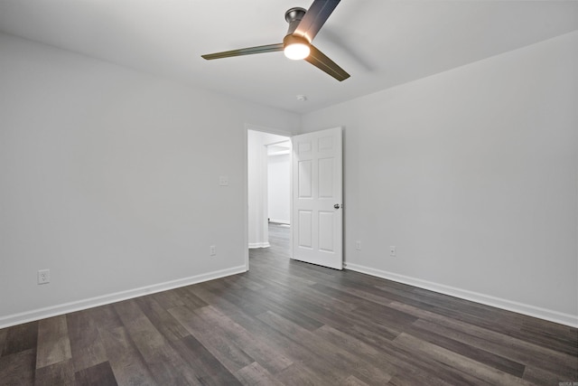 unfurnished room with dark wood-style floors, a ceiling fan, and baseboards