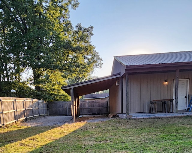 view of yard with a carport and a fenced backyard