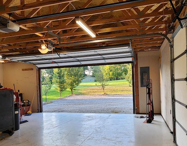 garage with electric panel and a garage door opener