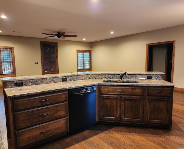 kitchen featuring dark brown cabinets, black dishwasher, wood finished floors, a ceiling fan, and a sink