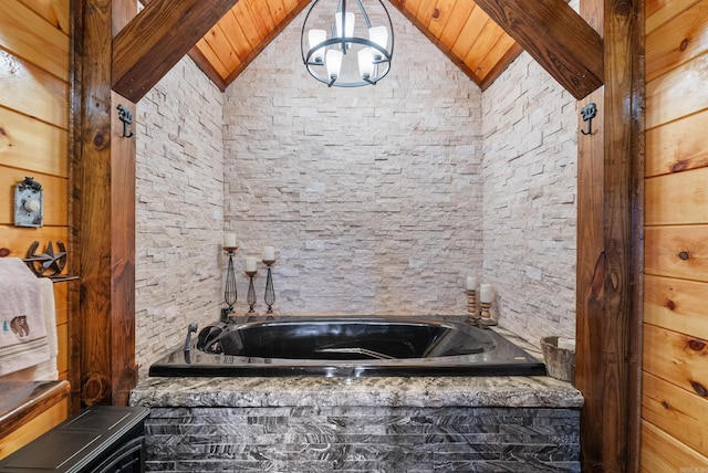 bathroom featuring lofted ceiling and a garden tub