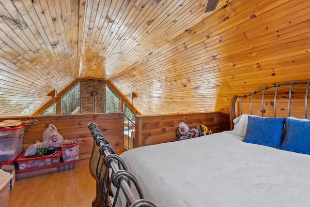 bedroom featuring wooden walls, wood ceiling, wood finished floors, and vaulted ceiling