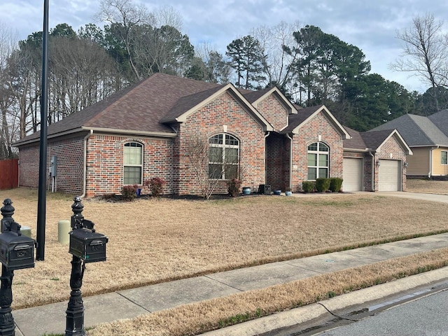 single story home with a garage, brick siding, roof with shingles, and driveway