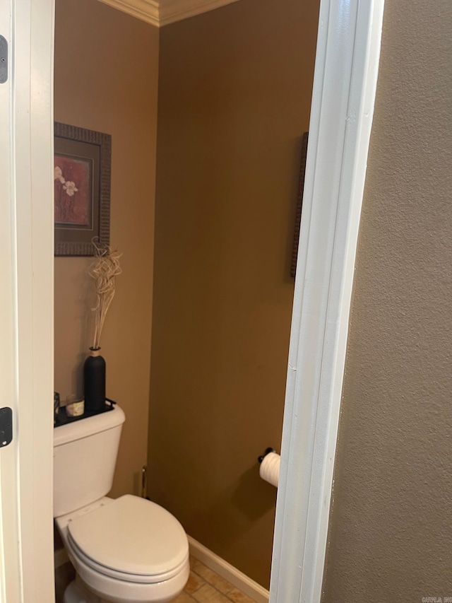 bathroom featuring baseboards, toilet, and tile patterned flooring