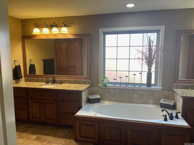 full bathroom featuring vanity and a bath