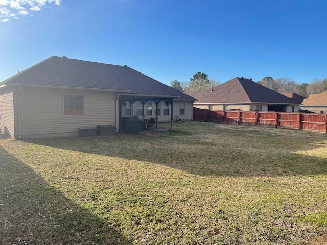 back of property featuring a patio area, a yard, and fence private yard