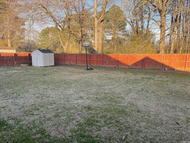 view of yard with a storage shed, a fenced backyard, and an outdoor structure