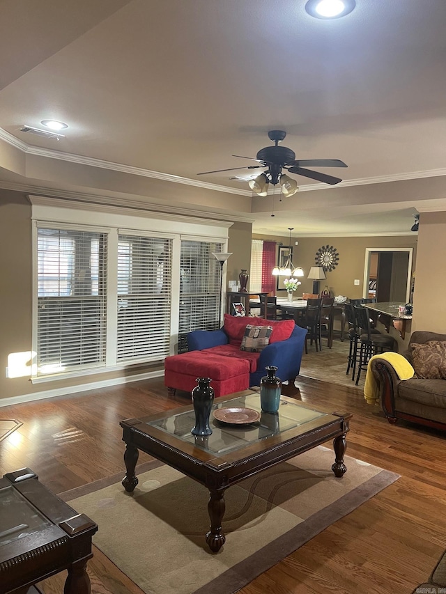 living area featuring ornamental molding, wood finished floors, recessed lighting, and ceiling fan