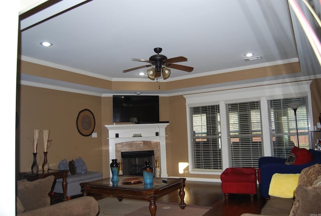 living area with visible vents, recessed lighting, a fireplace, crown molding, and ceiling fan