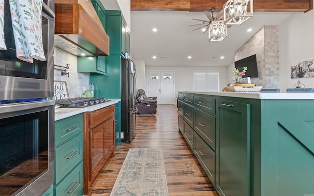 kitchen with green cabinets, light countertops, premium range hood, and stainless steel appliances