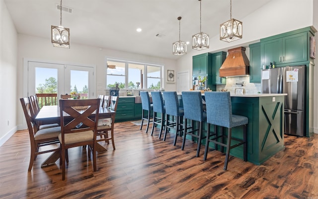 kitchen featuring custom exhaust hood, a notable chandelier, freestanding refrigerator, and green cabinetry