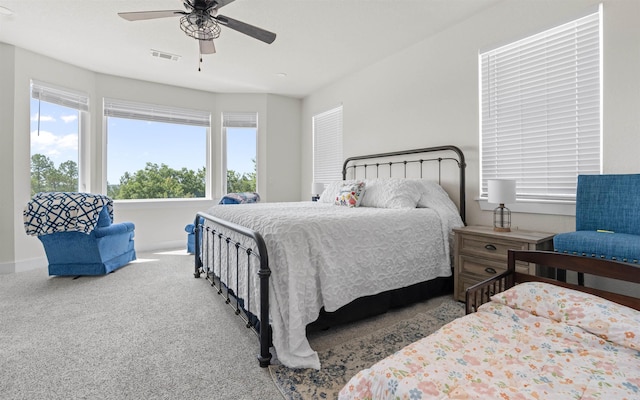 bedroom with baseboards, visible vents, a ceiling fan, and carpet