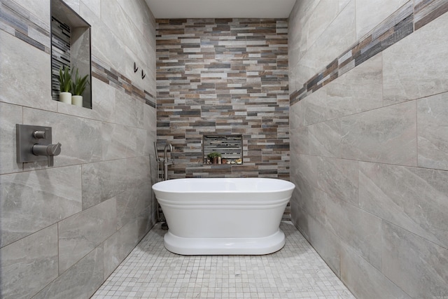 full bathroom featuring a soaking tub, tile walls, and tile patterned floors