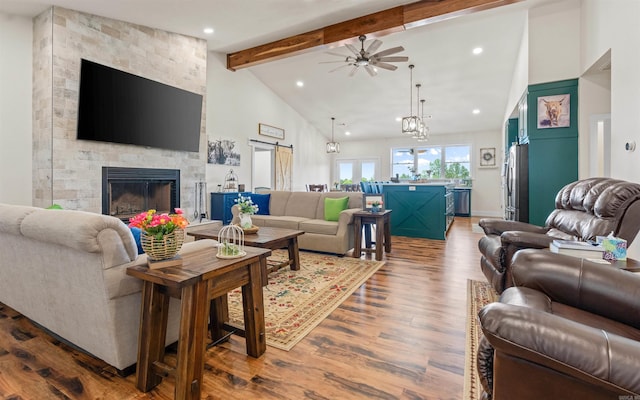 living room with dark wood-style floors, high vaulted ceiling, a fireplace, ceiling fan, and beamed ceiling