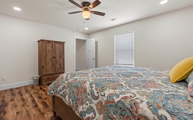 bedroom with recessed lighting, wood finished floors, visible vents, and baseboards